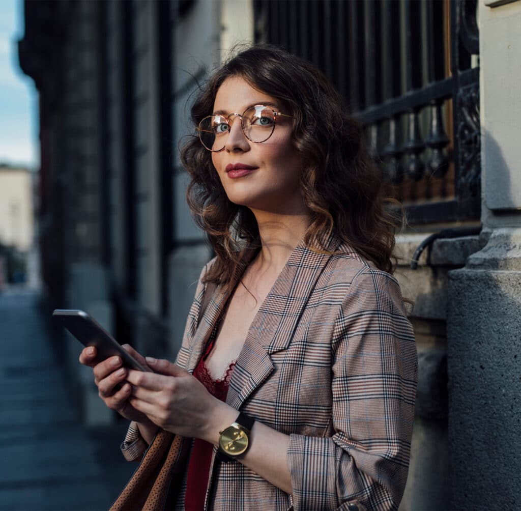 on phone outside old building